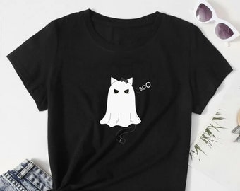 May include: Black t-shirt with a white ghost with a black cat tail and a bow on its head. The ghost has angry eyes and says "BOO".
