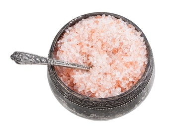 May include: A small silver bowl filled with pink Himalayan salt, with a silver spoon resting on top of the salt.