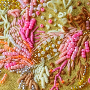 Close up of the 3D embroidery hoopart with beads and hand embroidery.