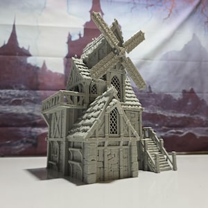 May include: A gray miniature windmill model with a detailed design. The model features a multi-level structure with a sloped roof, windows, and a balcony. The windmill blades are visible at the top, and a staircase leads to the upper level.