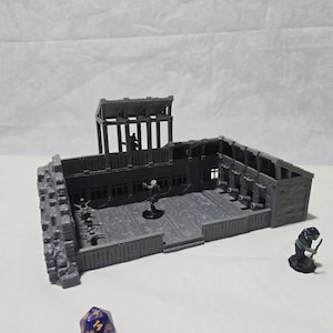May include: A gray, 3D-printed miniature dungeon terrain set. The set includes a multi-level structure with a raised platform, a watchtower, and several miniature figures. The set is designed for tabletop gaming.