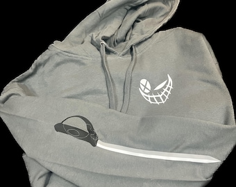 May include: A gray hooded sweatshirt with a white smiling face graphic on the front and a white knife graphic on the sleeve.