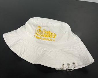 May include: White bucket hat with a gold embroidered logo that says "Fing Pings + Seoul Division +" and silver metal rings on the brim.