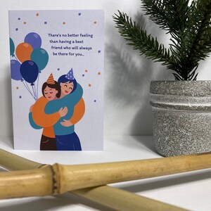 May include: A greeting card with a colorful illustration of two friends hugging. The card has the text "There's no better feeling than having a best friend who will always be there for you..."