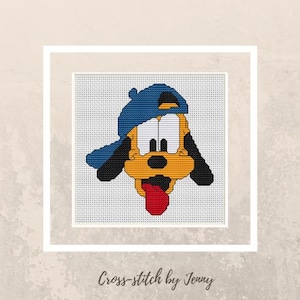 May include: Cross-stitch of a cartoon dog wearing a blue baseball cap, with a yellow face, black ears, and a red tongue sticking out. The text "Cross-stitch by Jenny" is at the bottom.