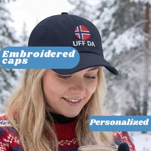 May include: Navy blue baseball cap with a Norwegian flag emblem and the text "UFF DA". The cap is embroidered and personalized. The image also includes the text "Embroidered caps" and "Personalized".