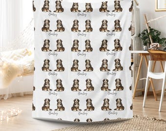 May include: White blanket featuring a repeating pattern of Bernese Mountain Dog illustrations. Each dog is depicted in a seated position, with the name "Bailey" written in cursive script below each image. The dogs are black, brown, and white.