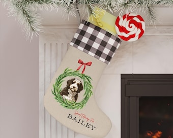 May include: A beige Christmas stocking with a black and white checkered cuff. It features a watercolor image of a dog in a green wreath and the text "Special Delivery For BAILEY". A red and white swirled lollipop is attached.