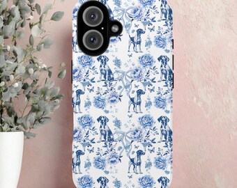 May include: A white iPhone 16 case featuring a blue floral and dog pattern. The design includes blue flowers, butterflies, and dog illustrations. The case has a camera cutout and the text "IPHONE 16" at the bottom.