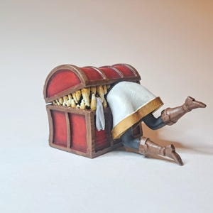 May include: A red wooden treasure chest with a gold trim is overflowing with gold coins. A person is reaching into the chest with their legs sticking out.