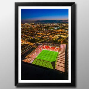 Umrahmter Druck Jubiläumsstickerei an der Anfield Road in der Abenddämmerung. Wandkunst, Poster, Football Club Memorabilie. You'll Never Walk Alone. Merseyseite.