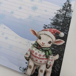 May include: A whimsical illustration of a lamb wearing a red and white Christmas hat and sweater with snowflakes. The lamb is also wearing a green scarf with holly berries. The background features a snowy landscape and a tall evergreen tree.