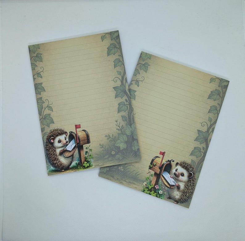 May include: Two sheets of lined stationery with a whimsical design. Each sheet features a cartoon hedgehog holding a letter at a mailbox. The paper has a vintage look with ivy and floral accents around the edges.