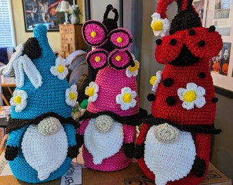 Red gnome with ladybug. Crocheted and adorned with black pom-poms.
