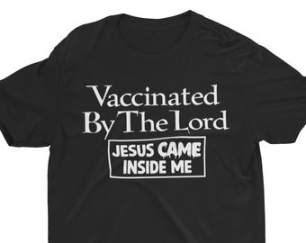 May include: Black t-shirt with white text that reads "Vaccinated By The Lord" and a white box with the text "Jesus Came Inside Me".