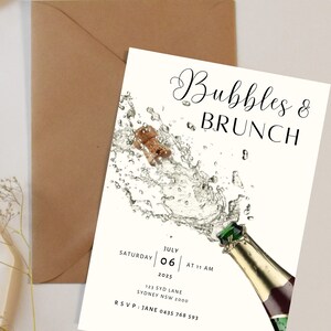 May include: A white invitation card with black text for a Bubbles & Brunch event. The card features a champagne bottle with a cork popping and a splash of bubbles. The event is scheduled for Saturday, July 06, 2025 at 11 AM. The address is 123 Syd Lane, Sydney NSW 2000. RSVP to Jane at 0435 768 593.