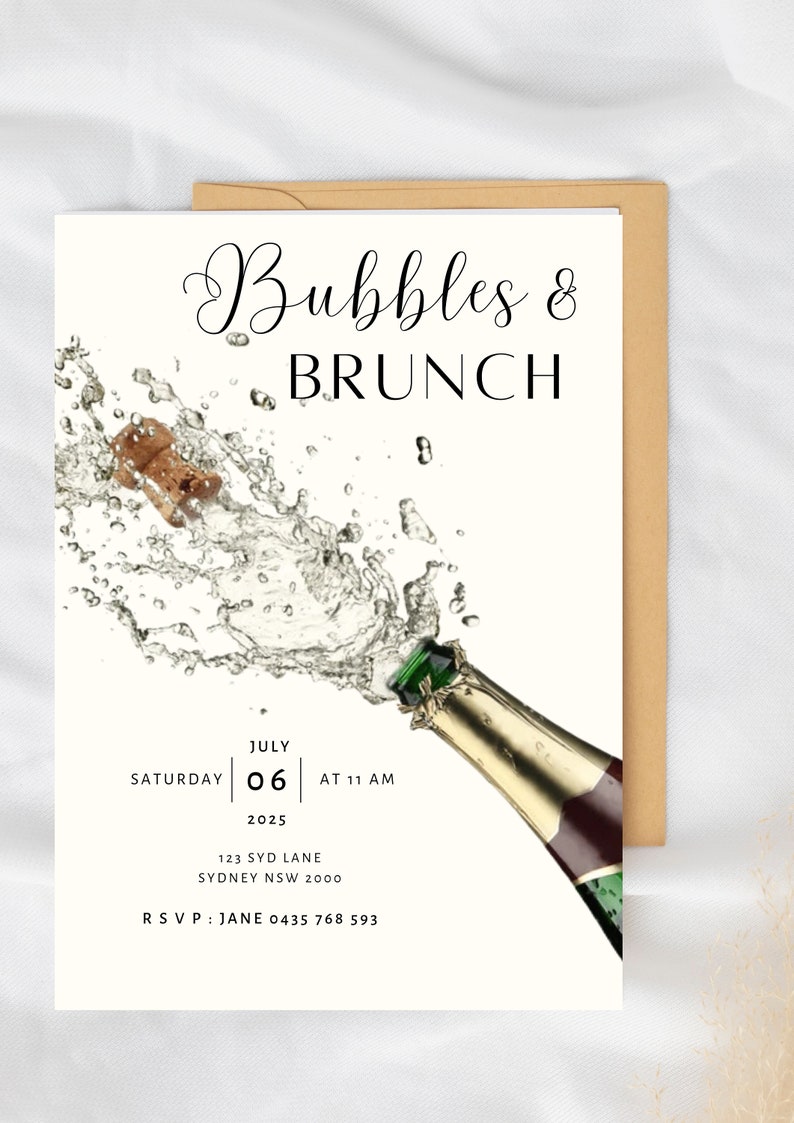 May include: A white invitation card with a champagne bottle popping with bubbles. The text on the card reads "Bubbles & Brunch", "Saturday July 06 at 11 AM 2025", "123 Syd Lane Sydney NSW 2000", and "RSVP: Jane 0435 768 593".