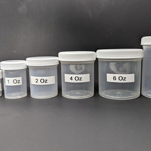 May include: Set of six clear plastic jars with white lids. The jars are labeled with their size in ounces: 0.5 oz, 1 oz, 2 oz, 4 oz, 6 oz, and 8 oz.