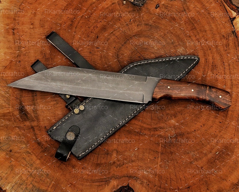 May include: A large, fixed blade knife with a brown wooden handle and a black leather sheath. The blade is made of steel and has a sharp point.