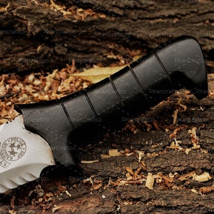 May include: A knife with a black handle and a silver blade. The blade has a serrated edge and a star-shaped design with the text "S.T.A.R.S. Raccoon Police Dept." on it.