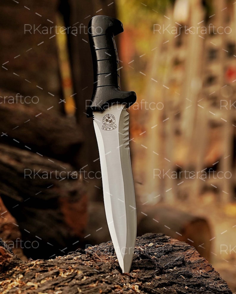 May include: A knife with a black handle and a silver blade. The blade has a serrated edge and a round emblem with the words "Special Forces" on it.