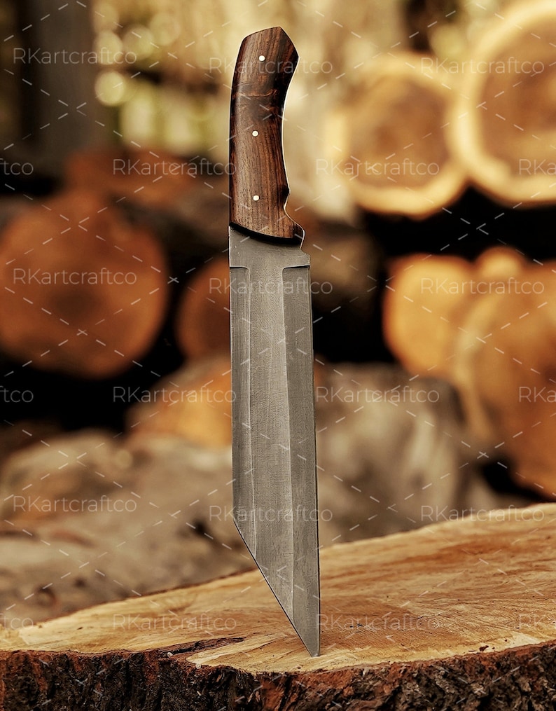 May include: A large, fixed blade knife with a dark wood handle. The blade is made of steel and has a sharp point. The knife is resting on a wooden surface.