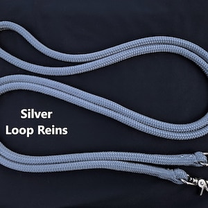 May include: Silver Loop Reins are made of a gray braided rope with silver metal clips on each end.
