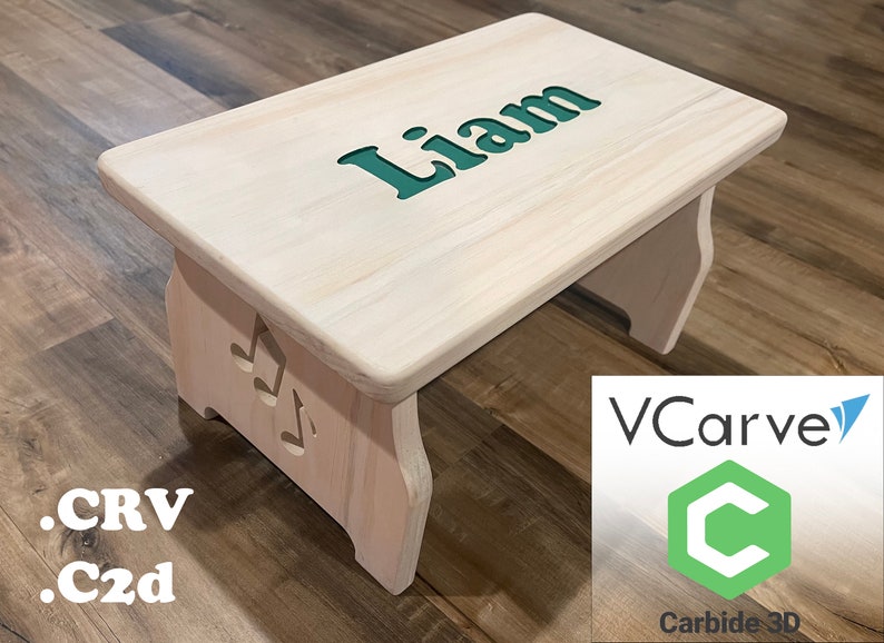 Finished picture of a single step children's step stool that is stained white, and a greenish blue inlayed text with the name 'Liam' on the top of the stool. The sides have music notes on them and text listing .crv, .c2d file extensions.