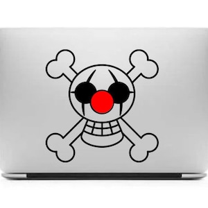 May include: A black and white skull and crossbones design with a red nose and black eyes. The design is on a silver laptop.