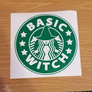 May include: Green and white sticker with a witch wearing a hat and the text "BASIC WITCH" in a circle.
