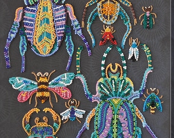 May include: A close-up of a beaded art piece featuring various colorful insects, including beetles, butterflies, and bees. The insects are arranged in a symmetrical pattern on a black background.