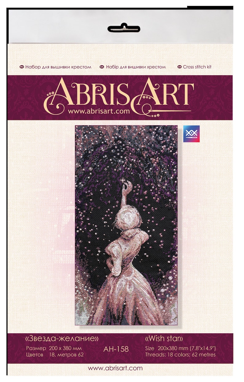 Pu&ograve; includere: Kit per punto croce con una donna che si protende verso un cielo stellato. Il kit include 18 colori di filo e misura 200 x 380 mm. Il logo "ABRIS ART" e l'indirizzo del sito web sono visualizzati sulla confezione.