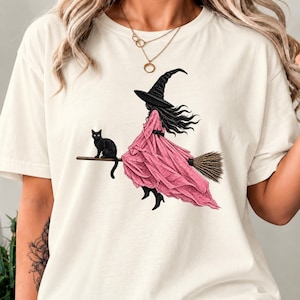 ハロウィン魔女シャツ（女性用）、ピンクの魔女と黒猫のTシャツ、かわいい魔女のハロウィンシャツ、不気味な季節のシャツ、魔女風の秋のギフト
