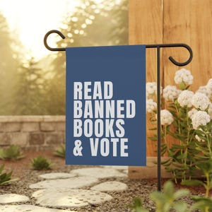 May include: A blue garden flag with white text that reads "READ BANNED BOOKS & VOTE".