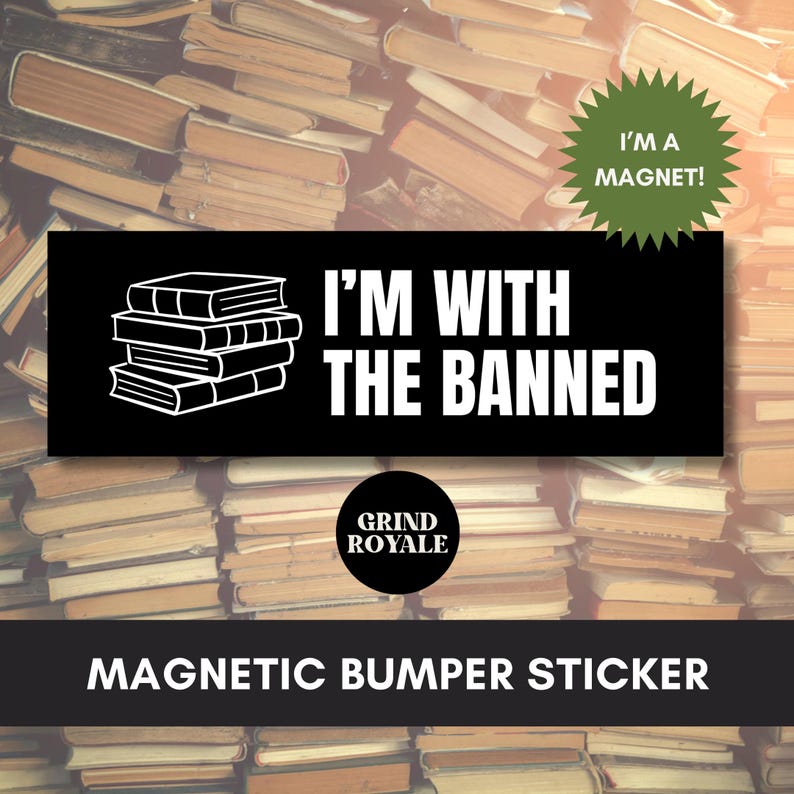 May include: Black magnetic bumper sticker with white text and a stack of books graphic. The text reads "I'M WITH THE BANNED". A green starburst sticker says "I'M A MAGNET!". The bottom of the sticker says "MAGNETIC BUMPER STICKER".