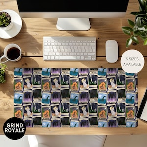 May include: A rectangular desk mat featuring a repeating pattern of tarot card illustrations. The cards depict various scenes with a mystical theme, including a wolf, a lake monster, and a full moon. The mat has the text "3 SIZES AVAILABLE" and "GRIND ROYALE".