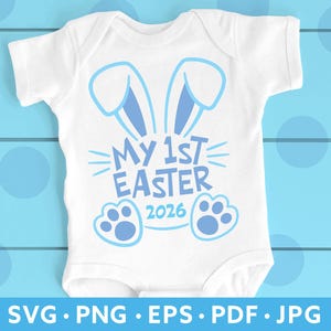 May include: White baby onesie with a blue bunny ears design and the text "MY 1ST EASTER 2026". The design includes bunny paws and radiating lines. The bottom of the image shows the file types: SVG, PNG, EPS, PDF, and JPG.
