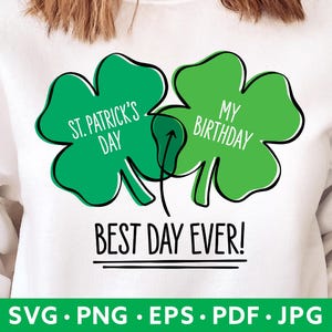 Op de afbeelding: Wit sweatshirt met een groen klavertjevier-ontwerp met de tekst "St. Patrick's Day" en "My Birthday" en daaronder de tekst "Best Day Ever!"