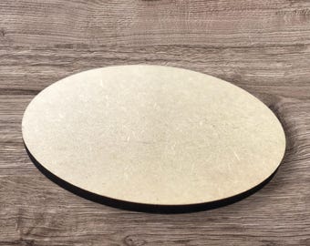 May include: An oval-shaped wooden coaster with a light beige surface and a black edge. The coaster is made of a light-colored wood material and is designed to protect surfaces from drink condensation.