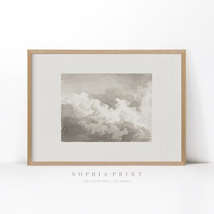 May include: A framed print of a watercolour painting of clouds in shades of grey and white. The print is in a light wood frame and has the text "Sophia Print" and "Only Paper Print / No Framed" below the image.