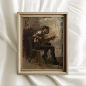 May include: A framed painting of a person sitting on a chair and playing a stringed instrument. The person is wearing a white shirt and dark pants. The background is a light brown color with a hint of blue.