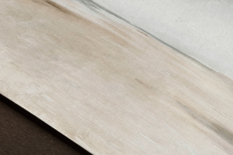 May include: A close-up of a light brown wood surface with a subtle grain pattern. The surface is smooth and appears to be lightly sanded.