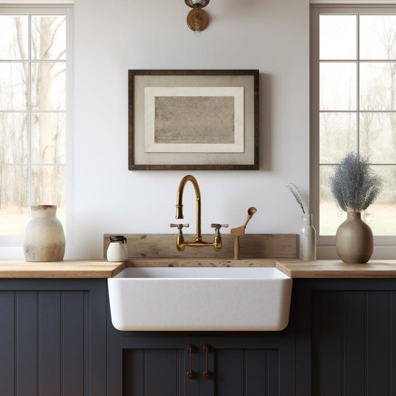 May include: A white farmhouse kitchen sink with a gold faucet and a wooden countertop. The sink is set against dark blue cabinets with a wood paneling design.