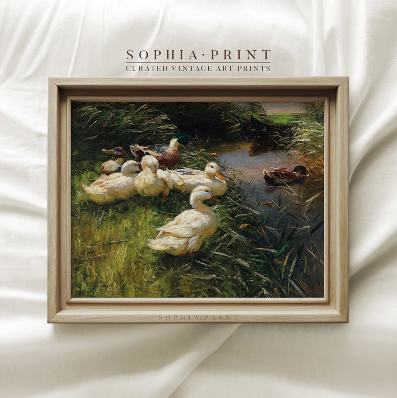 May include: A framed vintage painting of a group of ducks in a pond. The ducks are white with brown and green markings. The pond is surrounded by green grass and reeds. The painting is in a wooden frame with a white mat.