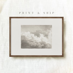 May include: A framed print of a watercolour painting of a cloudy sky in shades of grey. The print is in a brown frame and is ready to be hung on a wall.