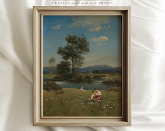May include: A framed vintage art print depicting a landscape scene with a river, trees, and figures in the foreground. The print is in a light wood frame with a white mount.
