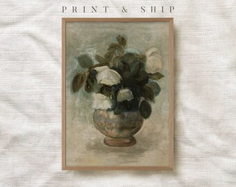 May include: A vintage painting of a bouquet of white roses in a brown vase. The painting is framed in a light wood frame.