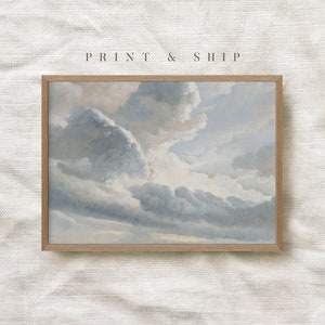 May include: A framed print of a painting depicting a cloudy sky with shades of blue and gray. The clouds are layered and textured, creating a sense of depth and movement. The print is framed in a light wood frame.