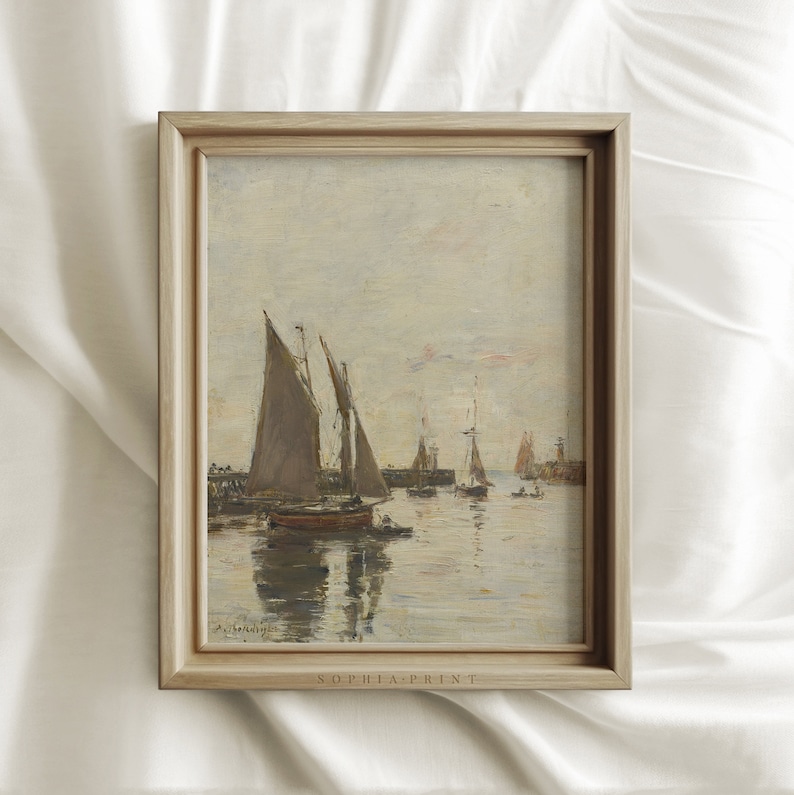 May include: A framed painting of a seascape with several sailboats in a harbor. The sky is a pale blue with a few clouds. The water is calm and reflective. The painting is in a light wood frame.