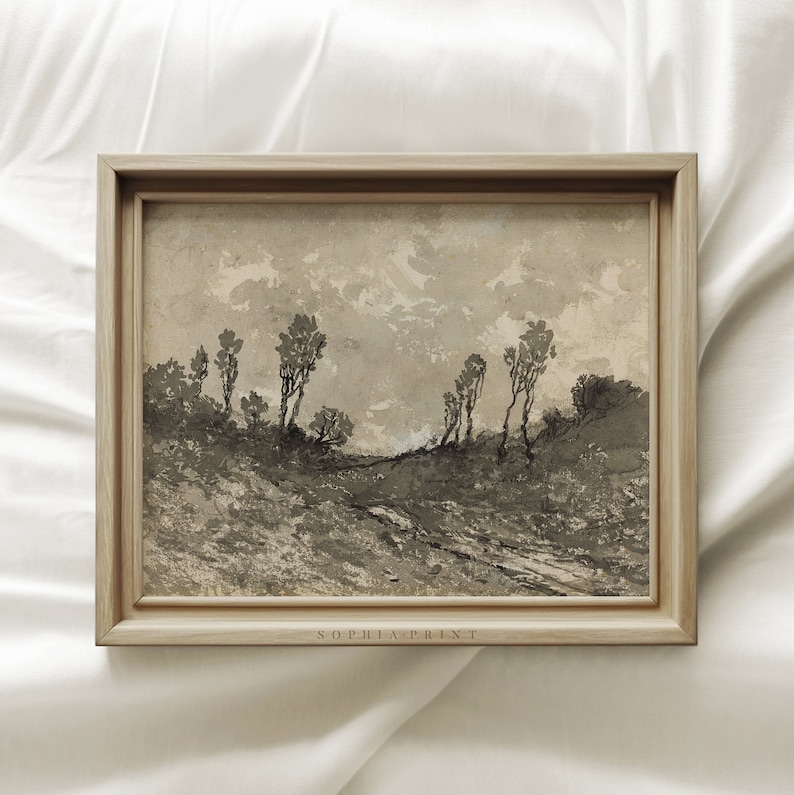 May include: A framed black and white landscape painting of a dirt road leading through a field of trees. The painting is in a light wood frame with a white mat.